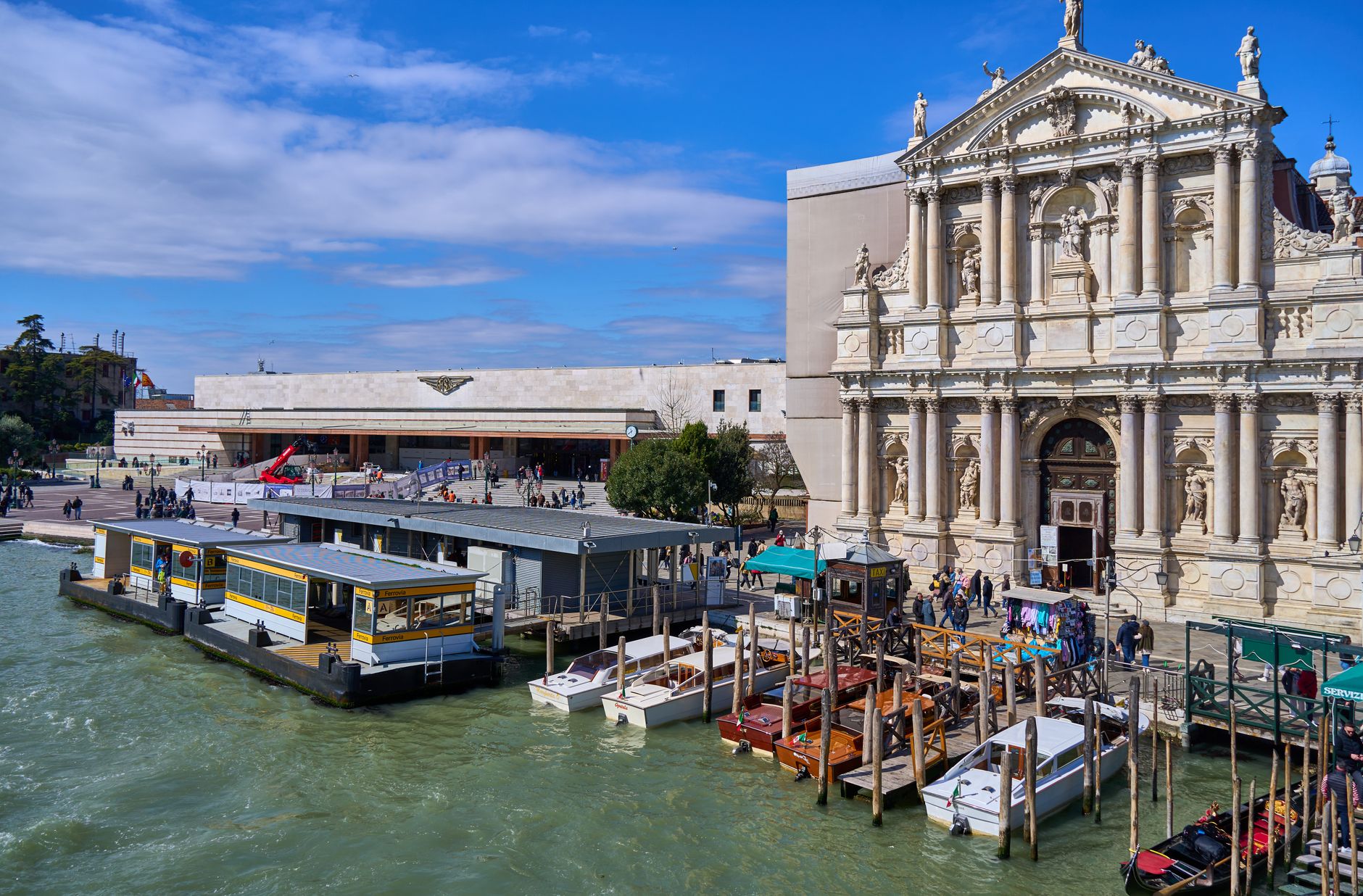 Venice's waterfront featuring San Simeone Piccolo and gondolas under a clear blue sky