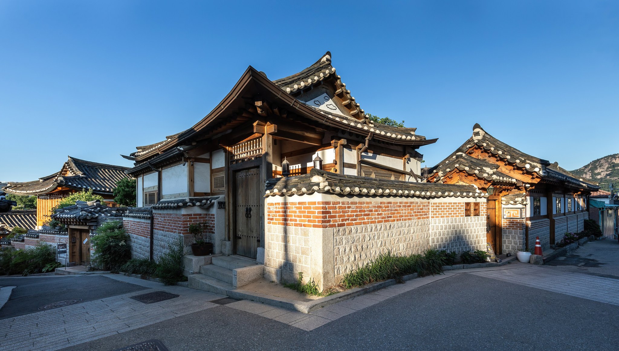 Traditional hanok houses and their tiled eaves in Bukchon at golden hour