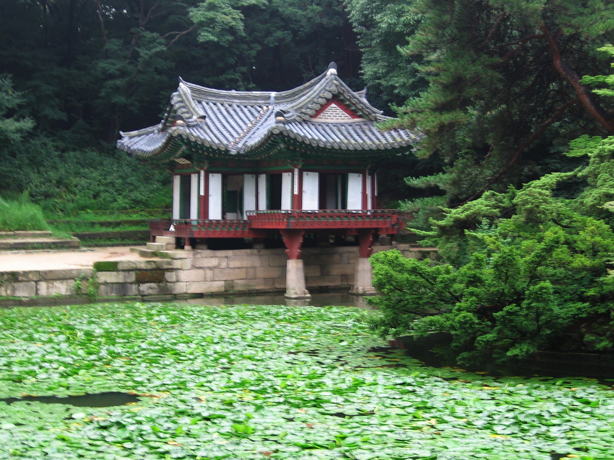 The Buyongjeong pavilion reflected in its square lotus pond in the Huwon garden