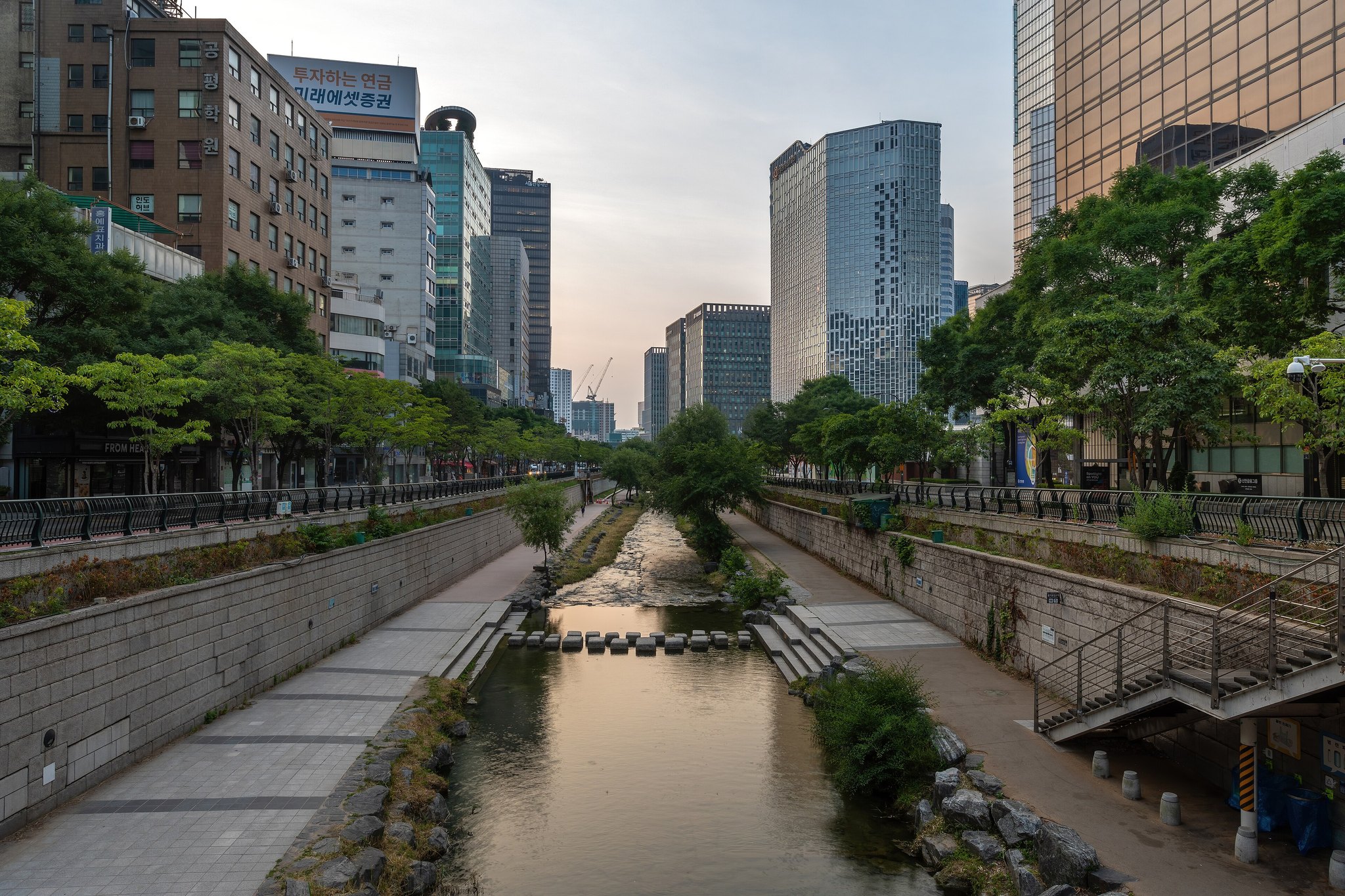 The Cheonggyecheon running between its stone walls below the level of the street