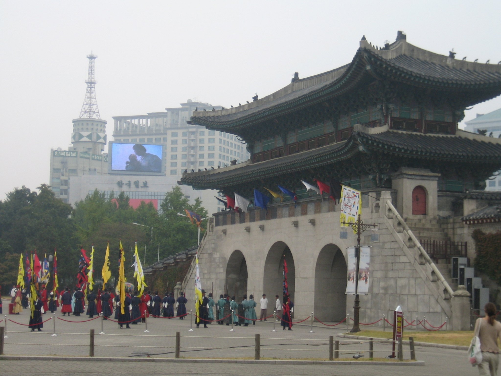 Guards in yellow and red Joseon costume lined up before the Gwanghwamun gate