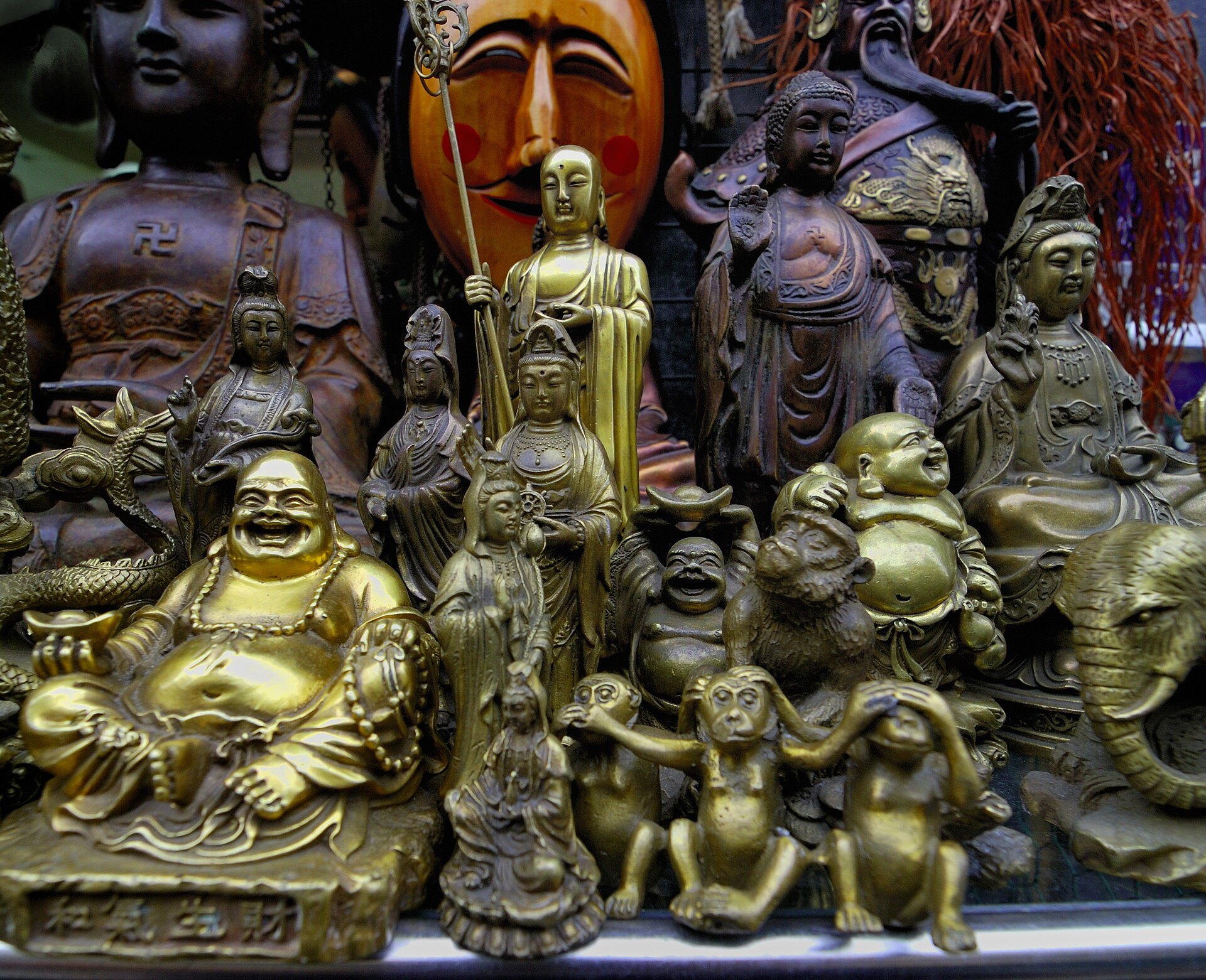 Brass and painted figures for sale on a shop front in Insadong