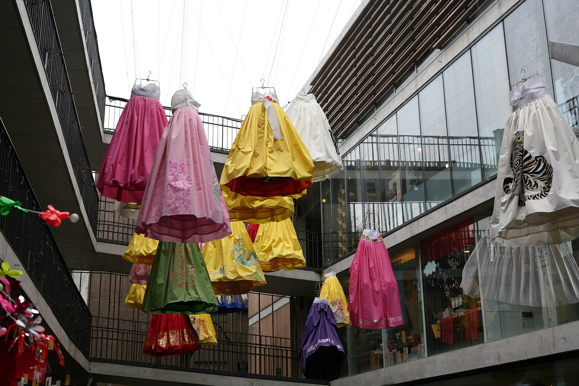 Hanbok and paper parasols hung in the open courtyard at Ssamziegil