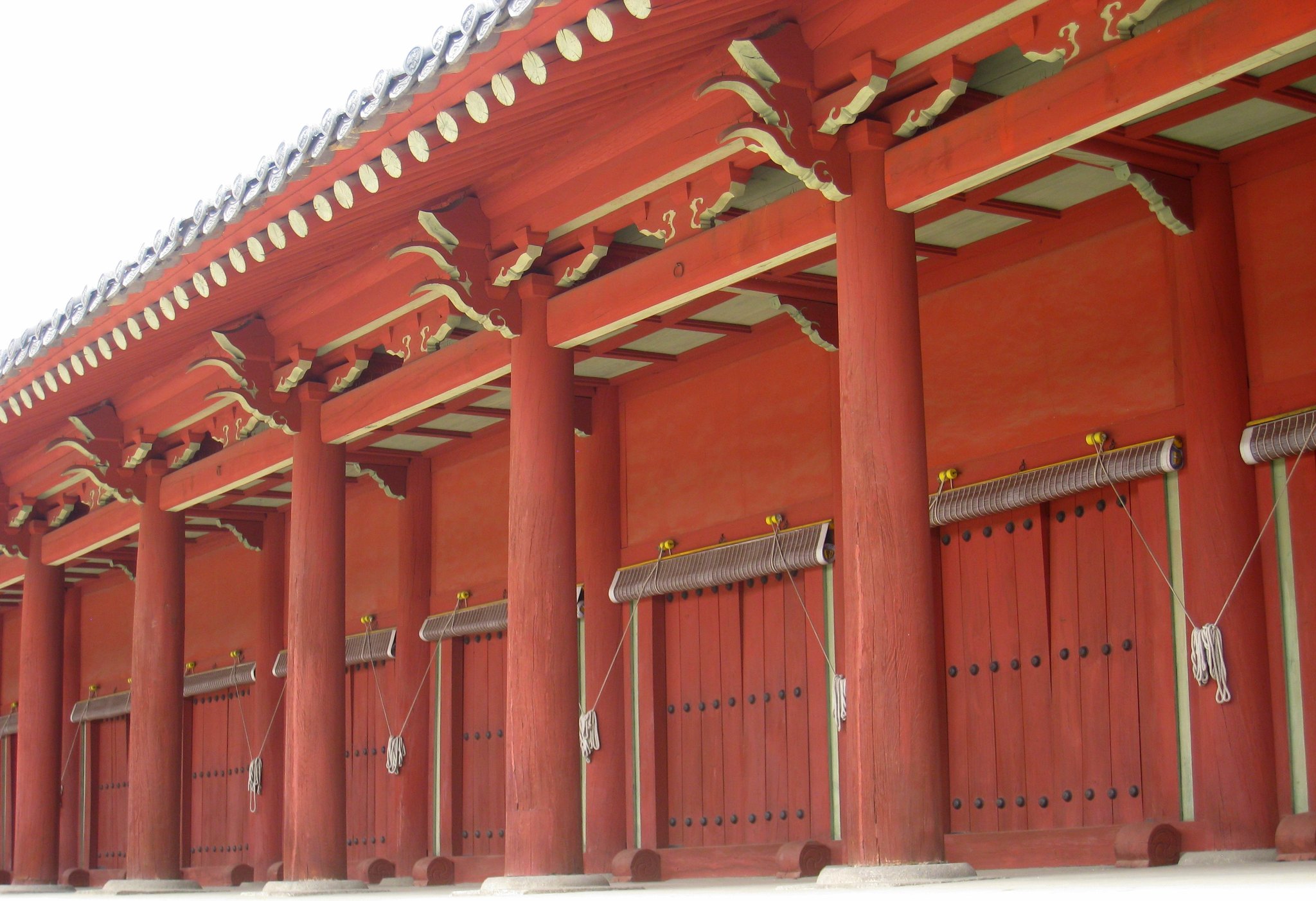 The red-painted colonnade and closed doors along the front of Jongmyo's main hall