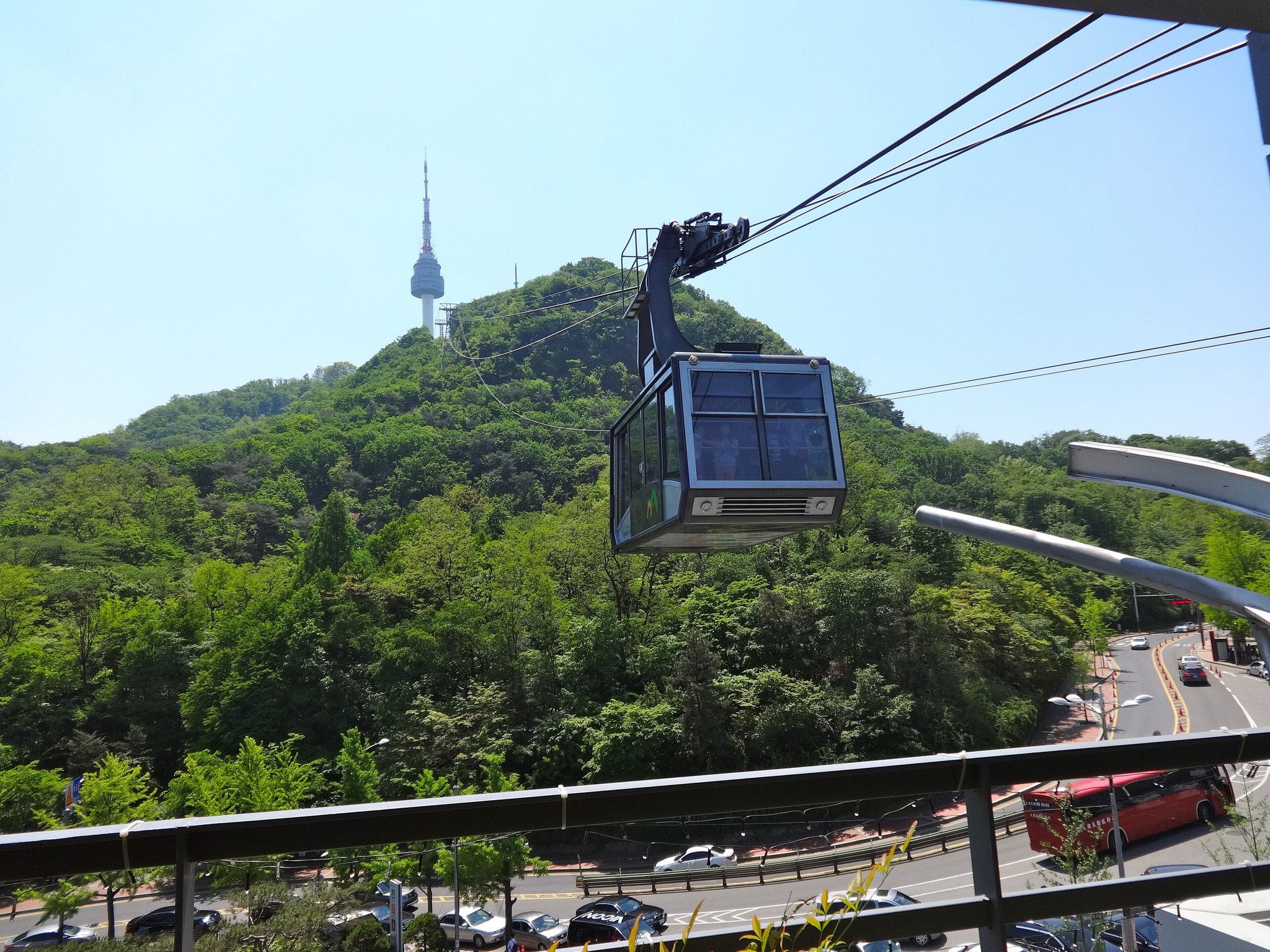 A cable car climbing the wooded slope of Namsan towards the tower at the summit