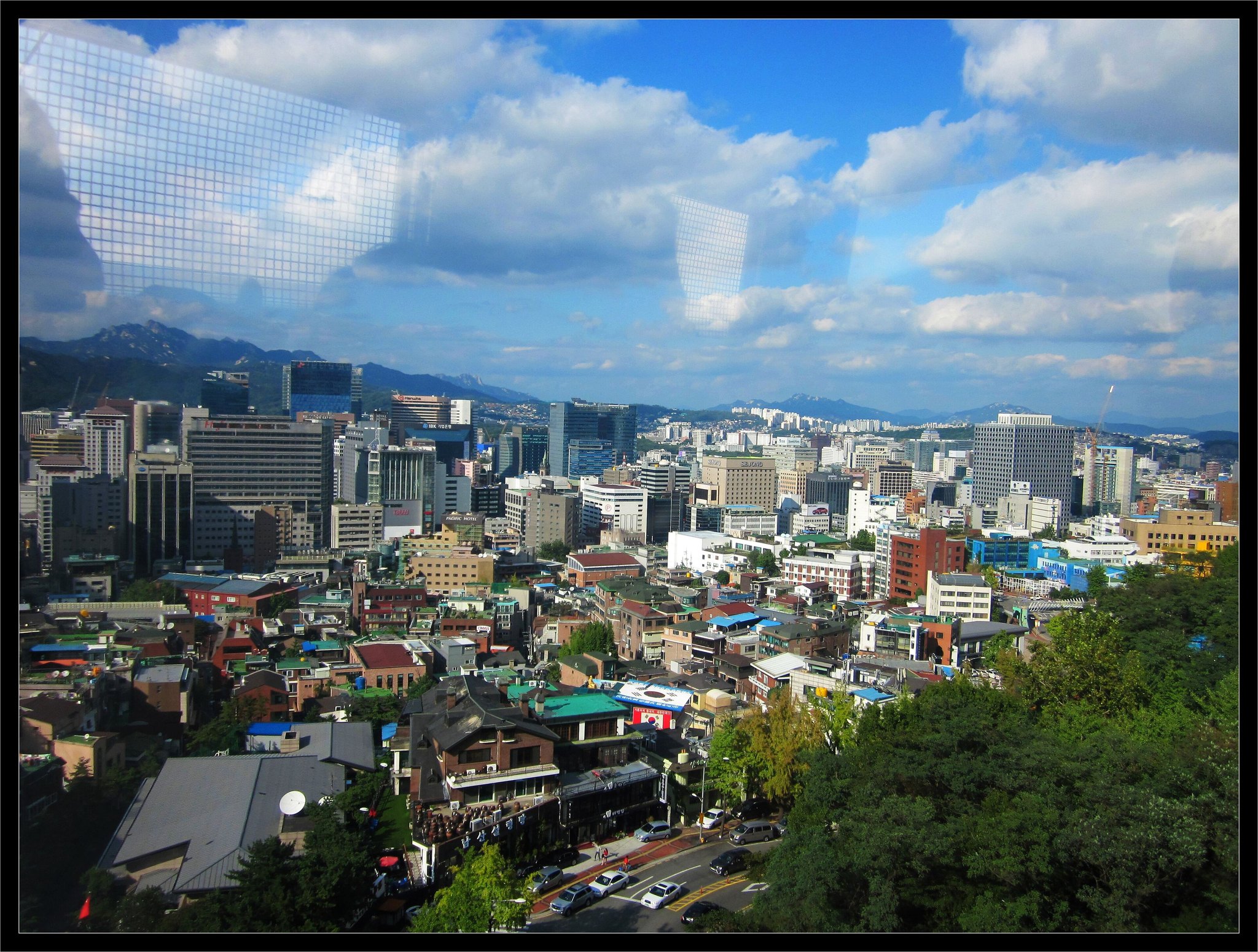 Central Seoul spread out to the hills, seen in daylight from the Namsan slope