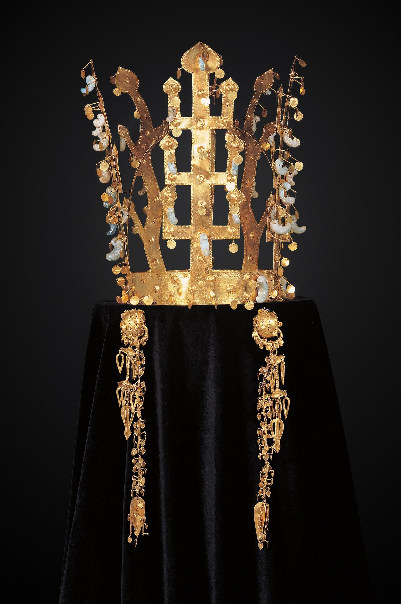 A Silla gold crown with its upright branch and antler shapes, in its case
