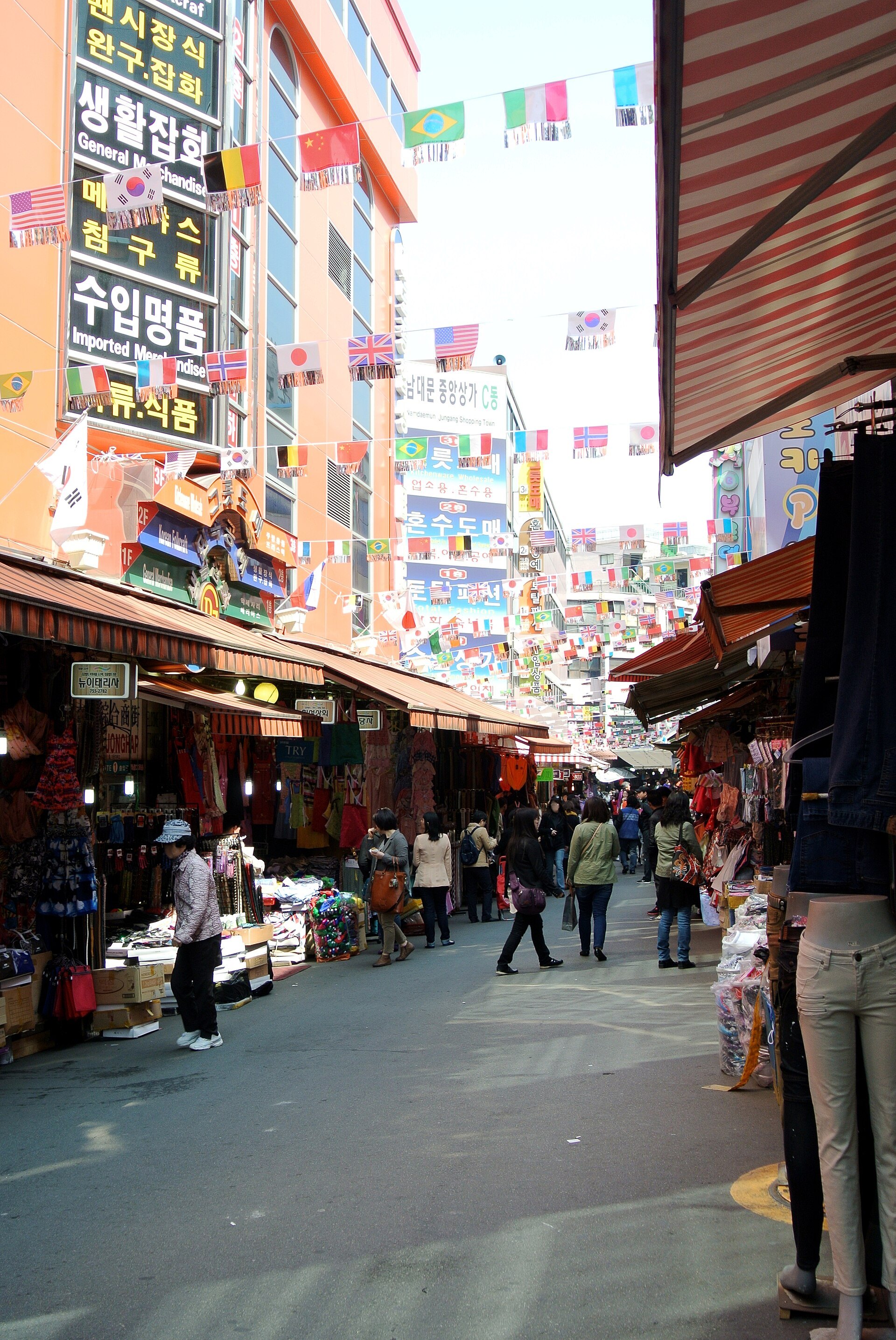 A narrow Namdaemun Market alley crowded with stalls and shoppers